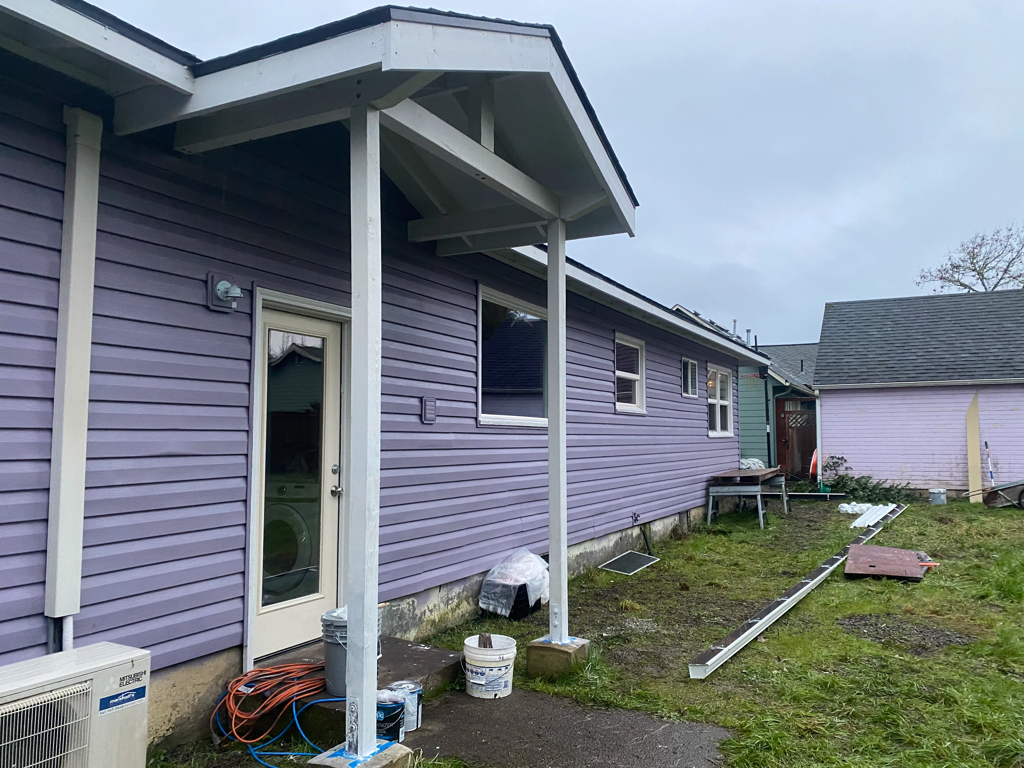 Covered rear entry addition with new exterior paint